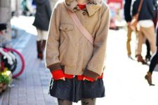a red sweater, a grey mini skirt, a neutral coat, printed tights, orange shoes