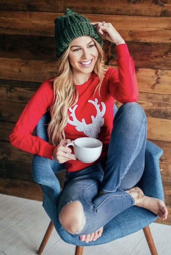 blue ripped jeans, a red sweatshirt with a deer and a green beanie to incorporate traditional colors