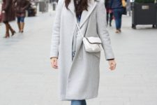 With beige coat, white bag, jeans and gray ankle boots