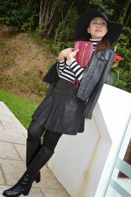 With black hat, black leather jacket, leather skater skirt and boots