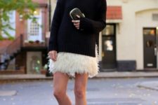 With black loose turtleneck sweater, clutch and black flats