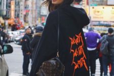 stylish look with an oversized hoodie and a mini backpack
