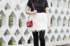 With black t-shirt, red mini bag, black tights and black ankle boots