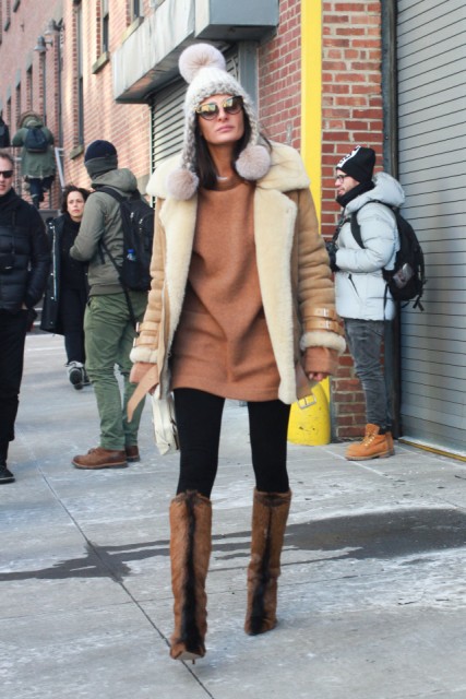 With brown sweatshirt dress, black tights, jacket and fur boots