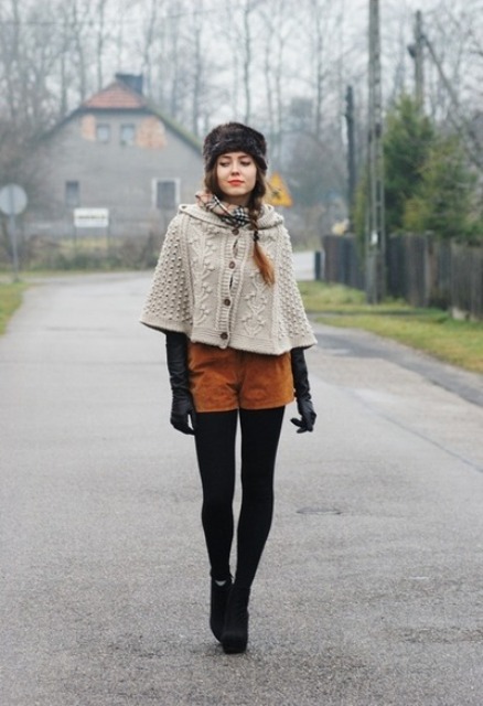 With fur hat, black tights, black high heeled boots, black gloves and beige cape coat