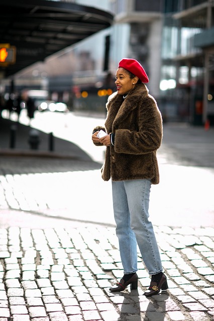 With fur jacket, loose jeans and heeled shoes