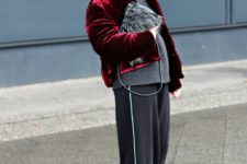 With gray sweater, black cap, fur clutch, wide leg pants and slip on shoes