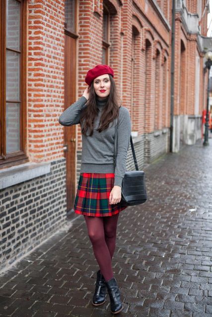 With gray turtleneck, plaid skirt, black leather bag and black boots