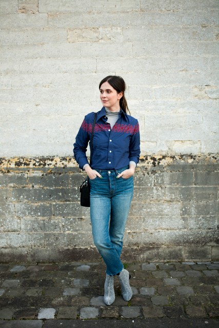 With gray turtleneck, two colored button down shirt, high-waisted jeans and black bag