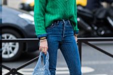 With green sweater, jeans and blue high heels