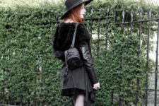 With leather and fur jacket, black skirt and black wide brim hat
