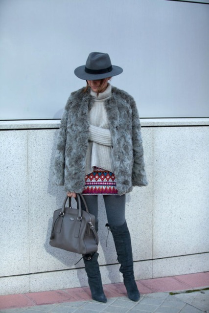 With printed skirt, gray tights, beige sweater, gray bag, over the knee boots and wide brim hat