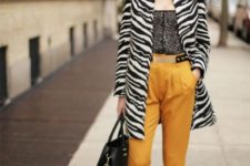 With printed top, yellow trousers, black tote and black shoes