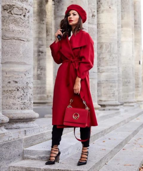 With red coat, black pants, red bag and high heels