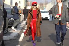 With red shirt, red leather trousers, purple shoes and brown coat