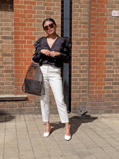 With ruffled blouse, white trousers and white shoes