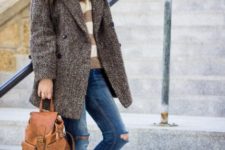 With striped sweater, coat, distressed jeans and white sneakers
