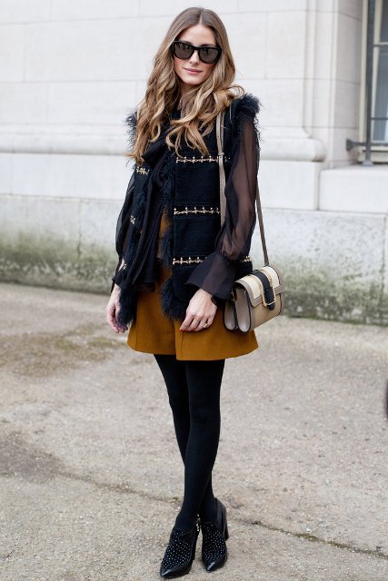 With vest, black tights, blouse, small bag and embellished shoes