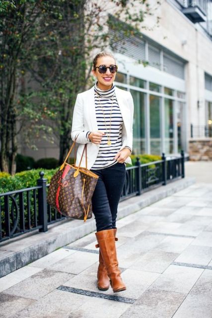 With white blazer, pants, brown high boots and printed tote