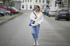 With white loose sweater, jeans and tote