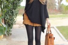 With wide brim hat, black loose blouse, black tights, brown suede ankle boots and brown leather tote
