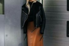 a black turtleneck, a rust midi leather skirt, matching boots, a black shearlign coat for an edgy touch