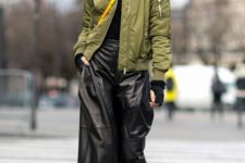 a black turtleneck, black cropped culottes, a green bomber jacket, blakc and white slipons and a beanie