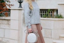 a blush pleated skirt, a grey sweater, black sock boots and a grey metallic bag with a shiny touch