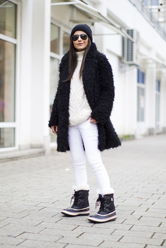 a creamy oversized sweater, white skinies, black fur winter boots and a black teddy coat
