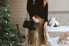 a festive look with a black oversized sweater, a metallic pleated skirt, black sock boots and a black bag