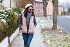 a grey turtleneck, blue jeans, a grey scarf, a white beret, a blush puffer vest and blush knee boots