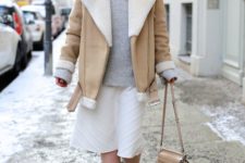 a grey turtleneck sweater, a creamy patterned skirt, a neutral shearling coat, neutral boots and a matching bag