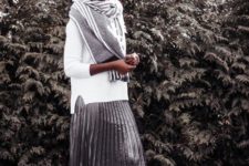 a metallic pleated skirt, a white sweater, a large grey scarf, white sneakers for a comfortable look