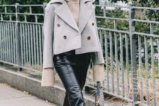 a neutral hoodie, black leather cropped pants, black shoes and a grey cropped coat