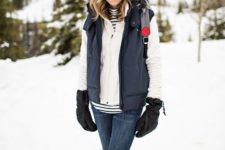 a snowy winter outfit with a striped top, a creamy hoodie, a black puffer vest, navy skinnies, ugg boots, a colorful beanie