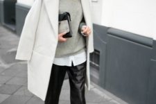 a white shirt, a grey sweater, a creamy coat, blakc cropped pants, black booties and a clutch