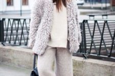 a white sweater, neutral cropped culottes, white sneakers and a neutral chunky teddy coat with a black bag
