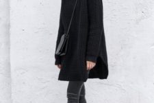 an oversized black turtleneck sweater, black cropped pants, black chelsea boots and a bag