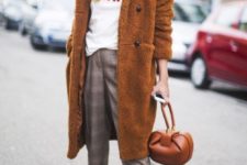 plaid cropped pants, a white sweatshirt, white sneakers, a mustard teddy bear coat, a brown bag and beanie