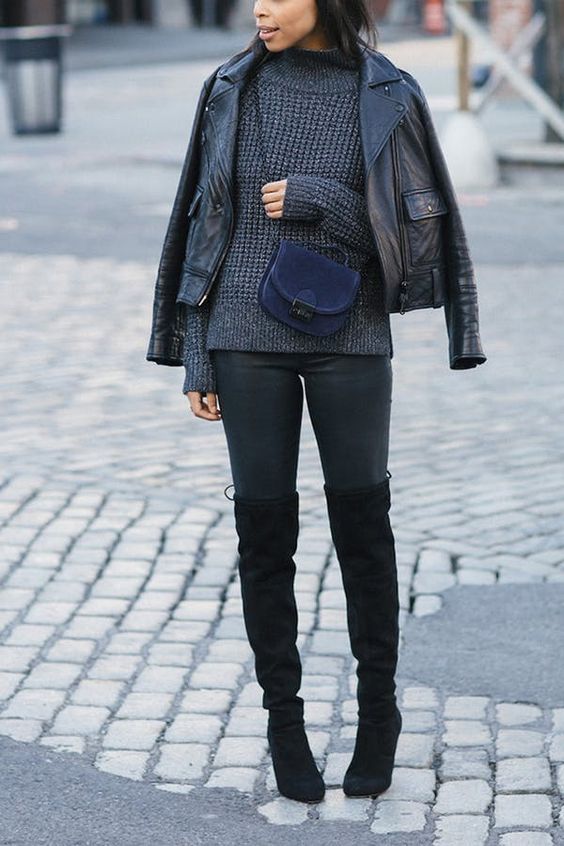black skinnies, black tall boots, a grey textured sweater, a black leather jacket and a navy bag