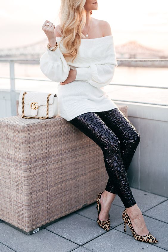a white off the shoulder sweater, black sequin leggings, leopard print shoes and a white bag