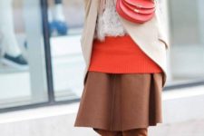 09 a coral oversized sweater, a brown midi skirt, brown tall boots, a camel coat and a matching scarf, a coral bag