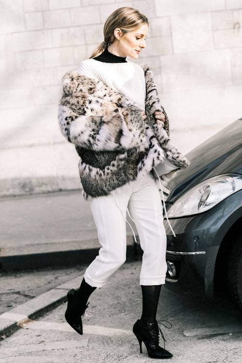 a white sweater over a black turtleneck, white cropped pants, blakc tights, black booties and a faux fur coat with an animal print