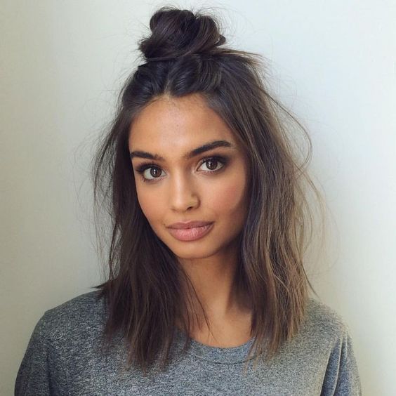 textural hair down and a top knot is a simple and casual hairstyle for holidays