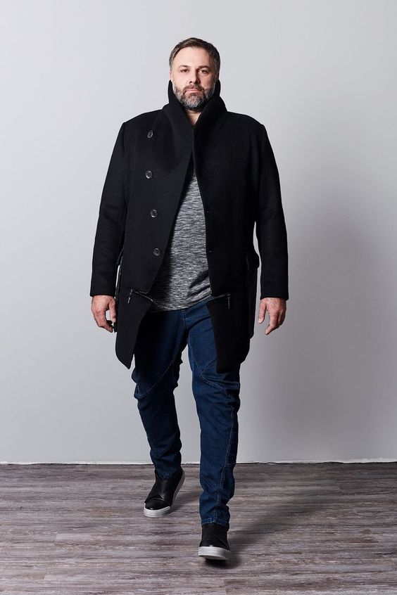 blue jeans, a grey sweater, a black coat, black sneakers for a stylish casual look