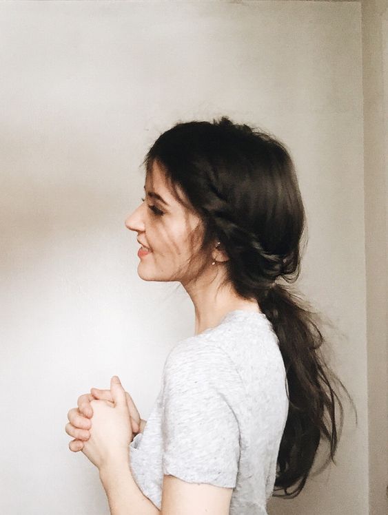a work-appropriate messy low ponytail with a braided halo is a cool boho chic idea to try