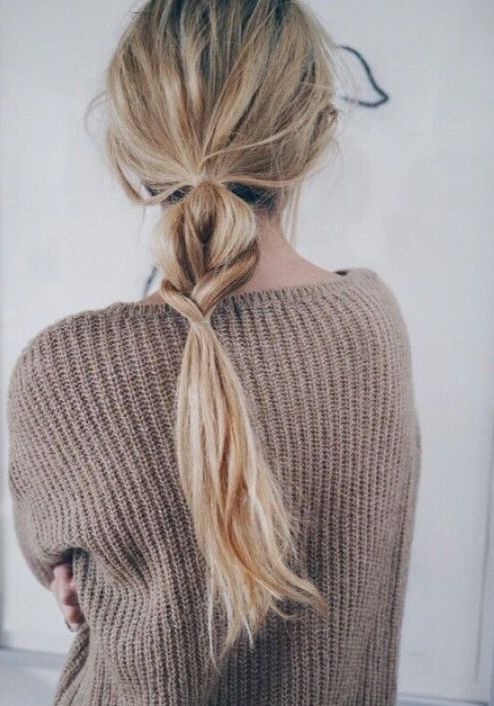 a messy low ponytail with a touch of braid integrated is a cool little hairdo for every day