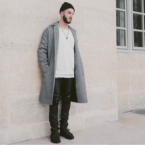 With beanie hat, gray midi coat, white t-shirt and black leather pants