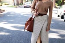 With beige shirt, brown leather tote and brown suede boots