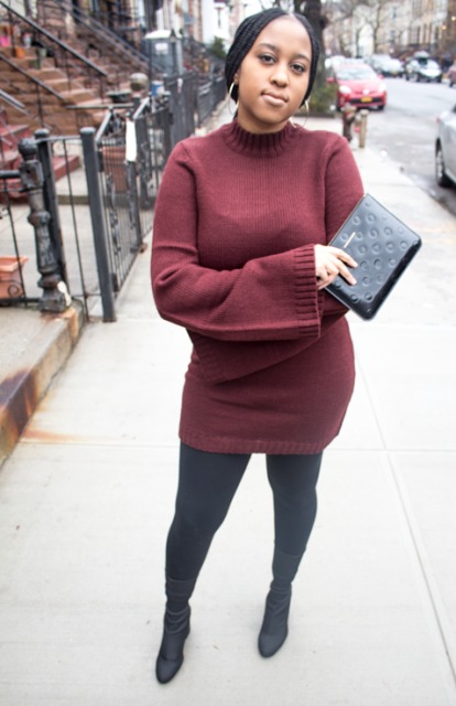 With black clutch, tights and mid calf boots